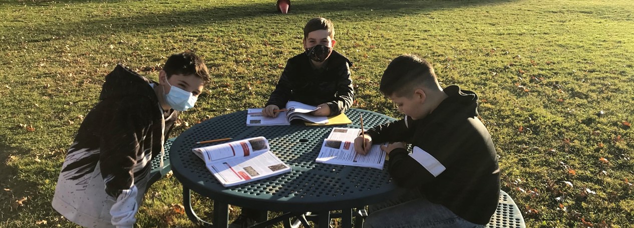 middle school students study outside